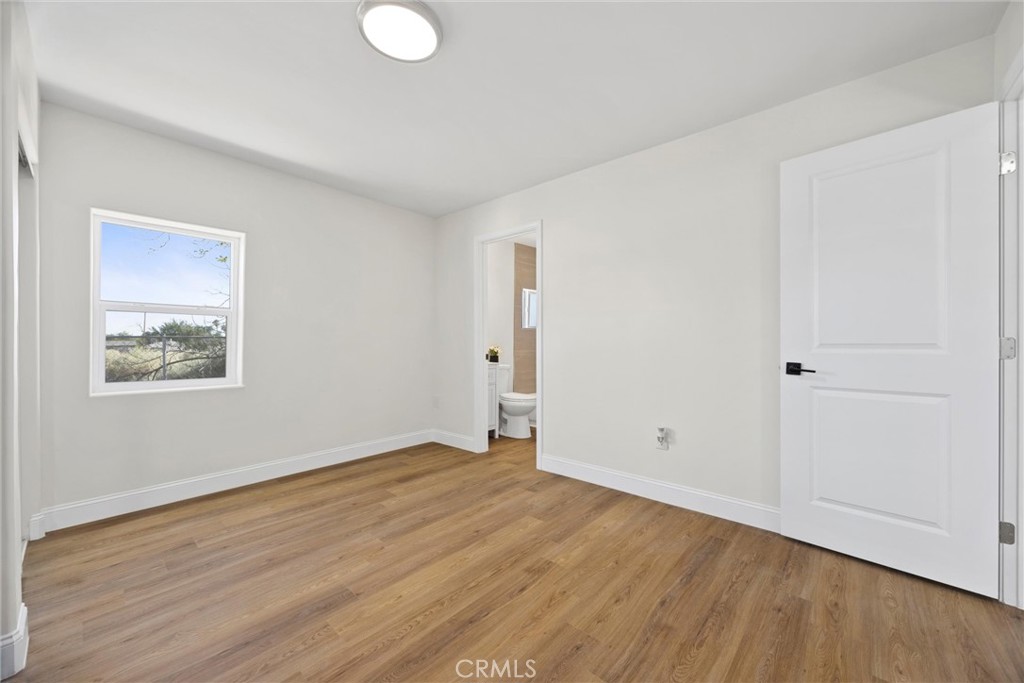102 Jackson Street Taft, CA 93268 - Photo 19 of 34 an empty room with wooden floor and windows