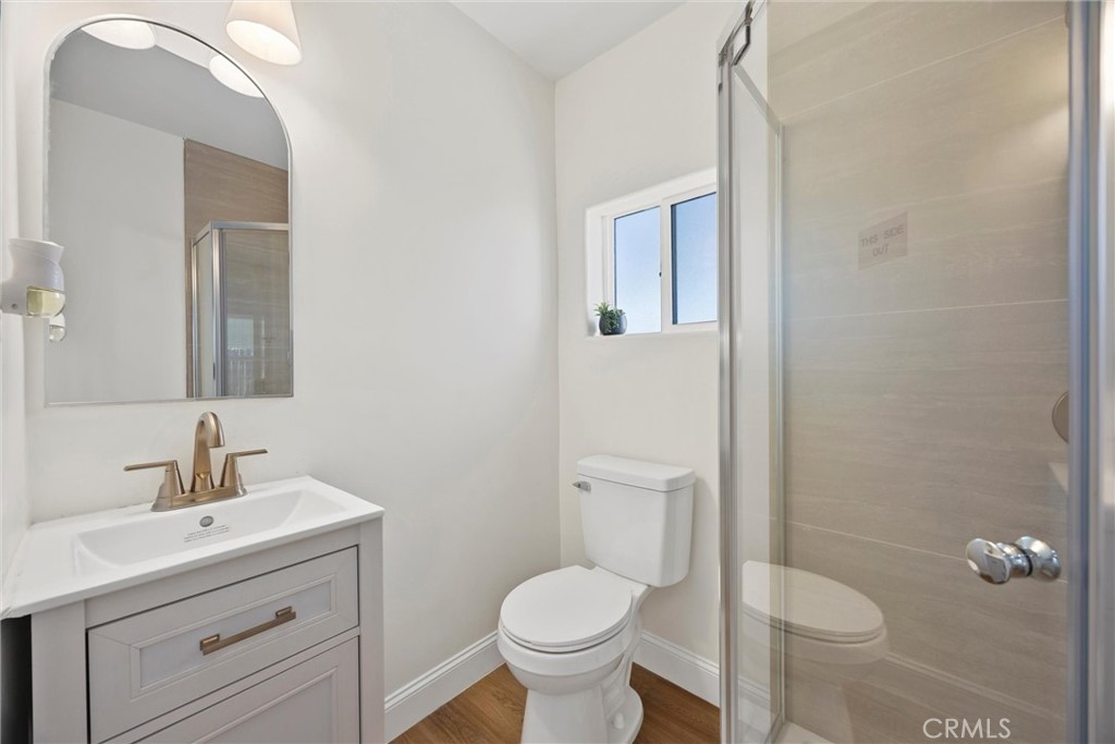 102 Jackson Street Taft, CA 93268 - Photo 22 of 34 a bathroom with a toilet sink and mirror