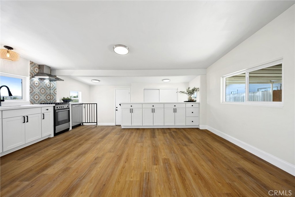 102 Jackson Street Taft, CA 93268 - Photo 9 of 34 a view of a kitchen with wooden floor and electronic appliances