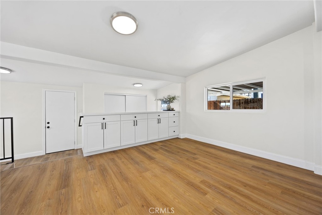 102 Jackson Street Taft, CA 93268 - Photo 10 of 34 an empty room with wooden floor and windows