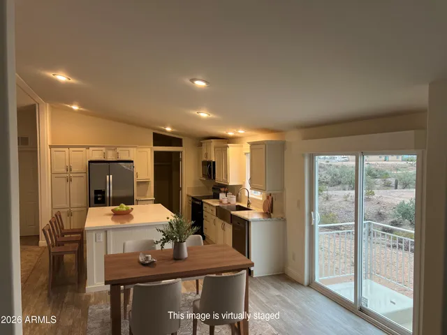 a kitchen with a table chairs refrigerator and cabinets