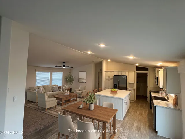 a living room with furniture a large window and a table