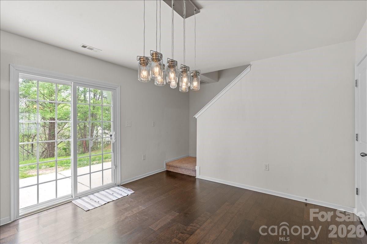 6066 Benedict Place, Unit 32 Fort Mill, SC 29707 - Photo 12 of 32 a view of a chandelier in big room with wooden floor