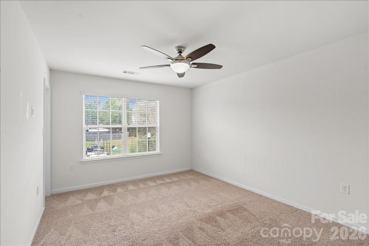 6066 Benedict Place, Unit 32 Fort Mill, SC 29707 - Photo 16 of 32 an empty room with a window and a fan