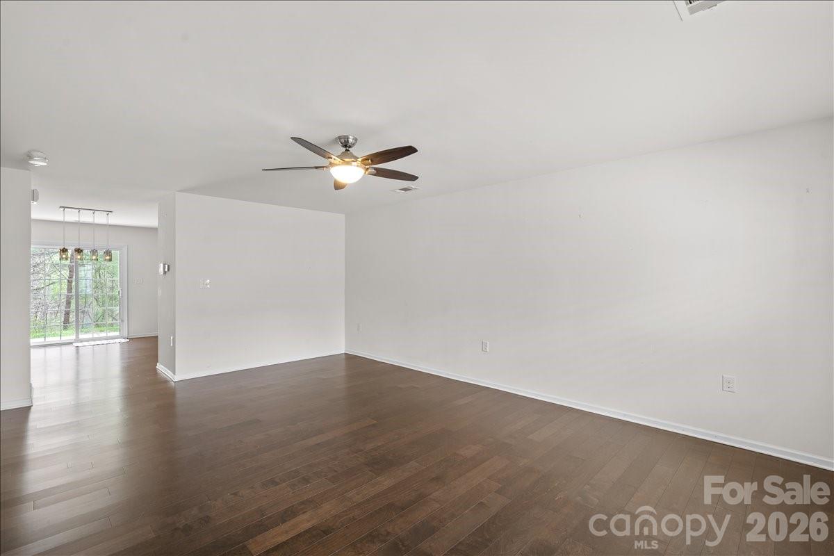 6066 Benedict Place, Unit 32 Fort Mill, SC 29707 - Photo 3 of 32 an empty room with wooden floor and windows