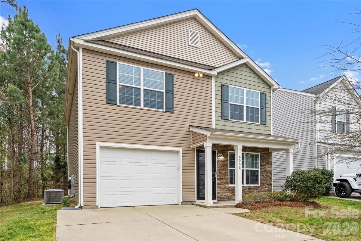 6066 Benedict Place, Unit 32 Fort Mill, SC 29707 - Photo 31 of 32 a front view of a house with garden