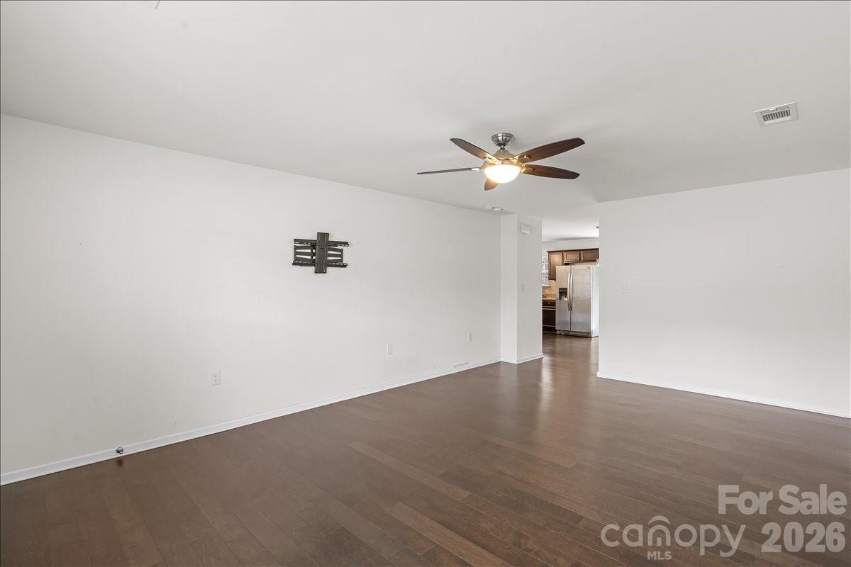 6066 Benedict Place, Unit 32 Fort Mill, SC 29707 - Photo 4 of 32 an empty room with wooden floor and ceiling fan