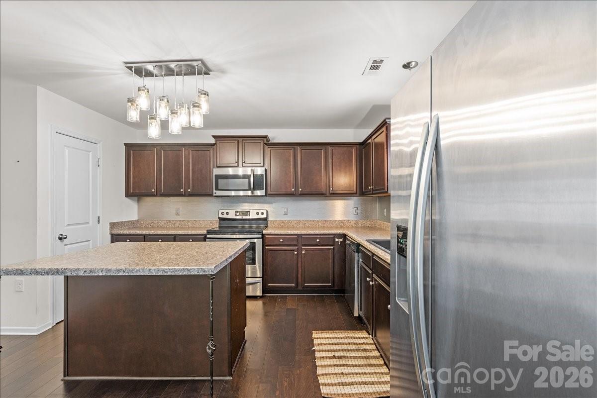 6066 Benedict Place, Unit 32 Fort Mill, SC 29707 - Photo 9 of 32 a kitchen with stainless steel appliances granite countertop a sink a stove a refrigerator and cabinets