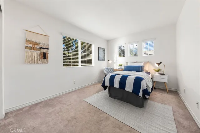 a bedroom with a bed lamp and a window