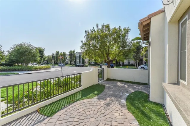 a view of a balcony with a yard