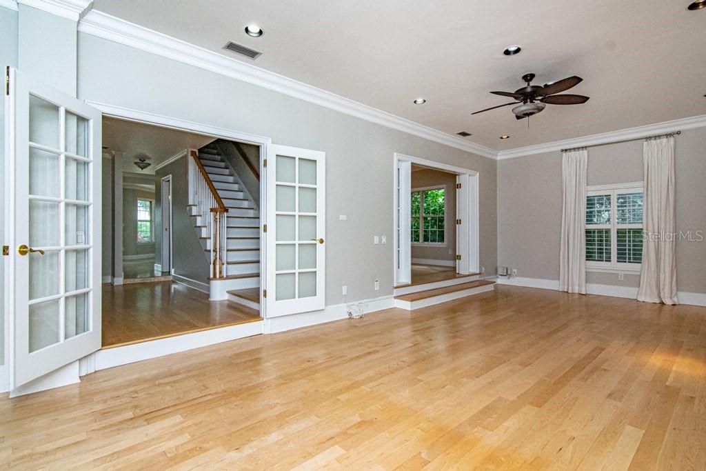 16405 Avila Boulevard Tampa, FL 33613 - Photo 13 of 61 a view of an empty room with a window and wooden floor