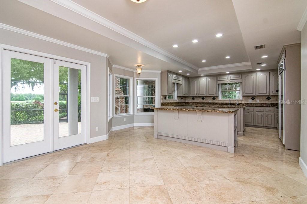 16405 Avila Boulevard Tampa, FL 33613 - Photo 17 of 61 a view of kitchen with stainless steel appliances granite countertop a stove top oven a sink and a island