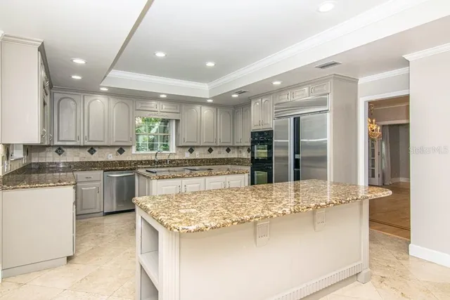 a view of a kitchen with granite countertop cabinets and window