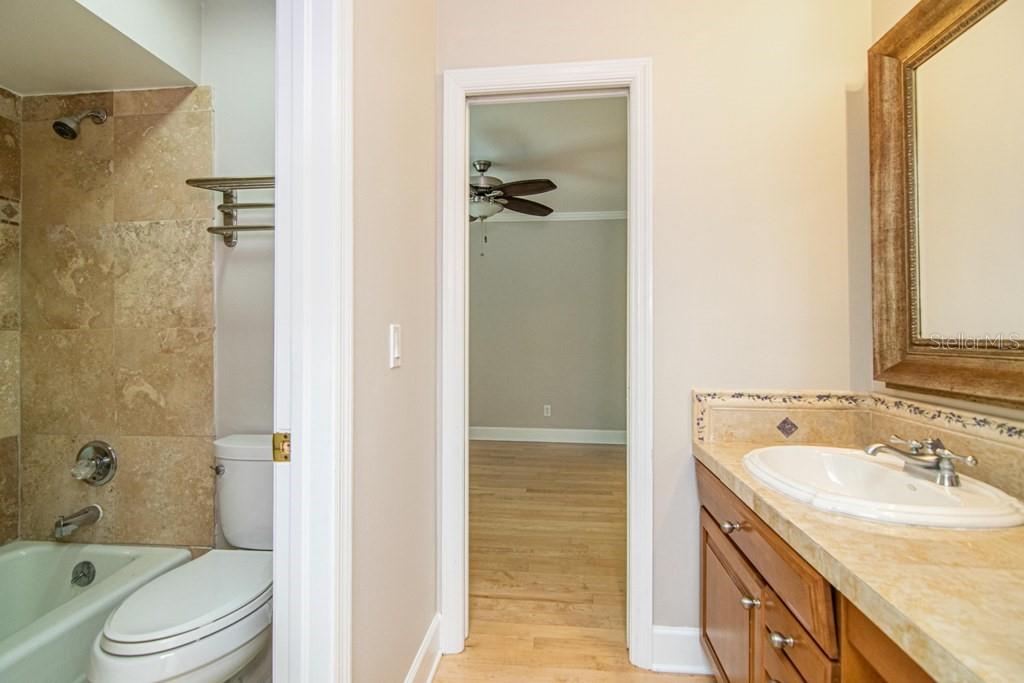 16405 Avila Boulevard Tampa, FL 33613 - Photo 39 of 61 a bathroom with a granite countertop sink toilet and shower