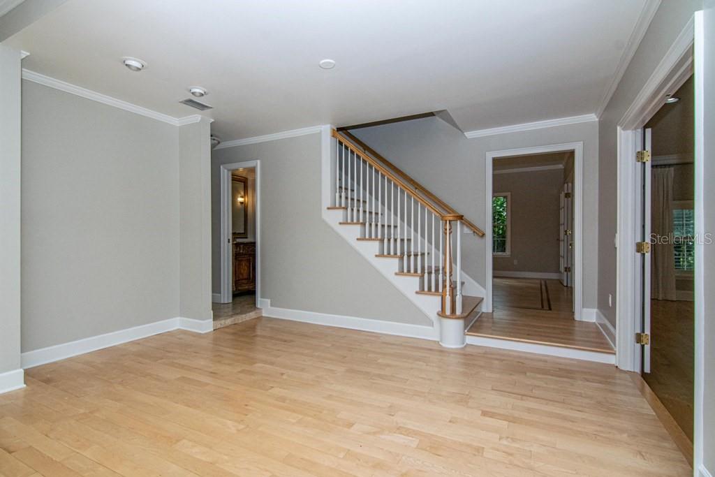 16405 Avila Boulevard Tampa, FL 33613 - Photo 7 of 61 a view of entryway with wooden floor