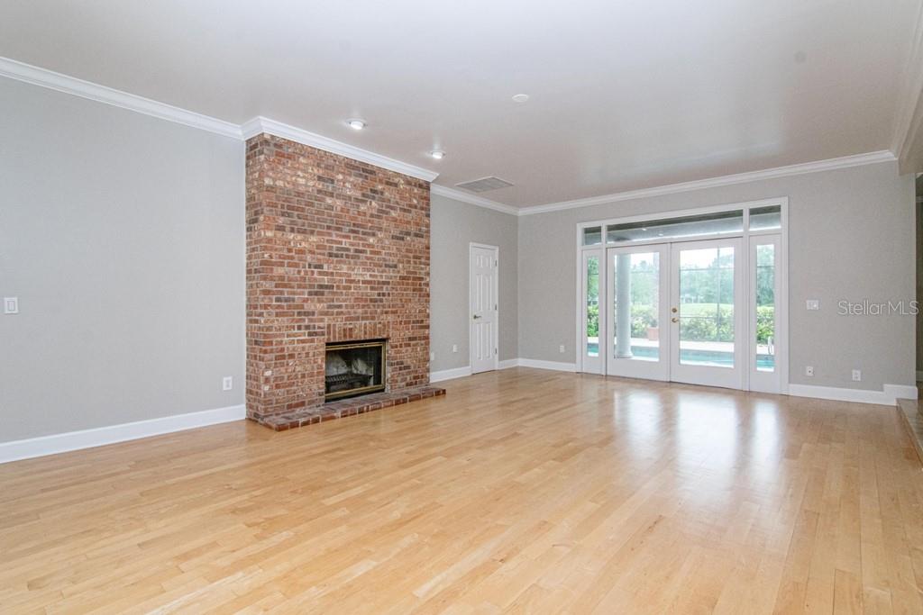 16405 Avila Boulevard Tampa, FL 33613 - Photo 8 of 61 wooden floor fireplace and natural light in room