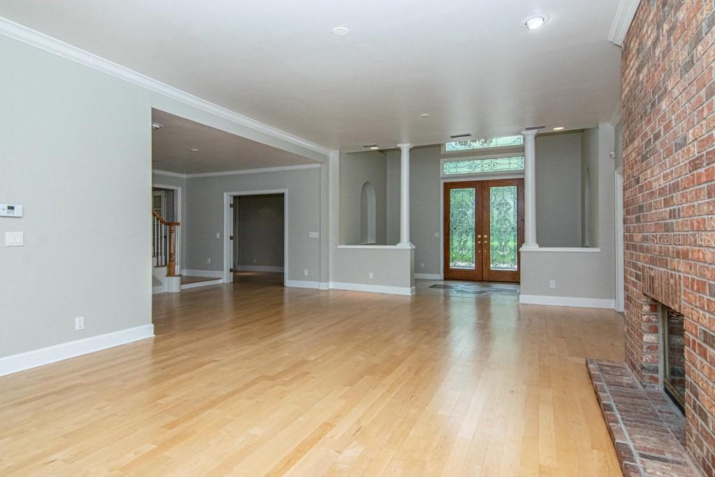 16405 Avila Boulevard Tampa, FL 33613 - Photo 10 of 61 a view of an empty room with window and wooden floor