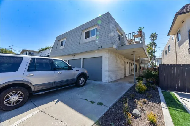 a view of a car parked front of a house