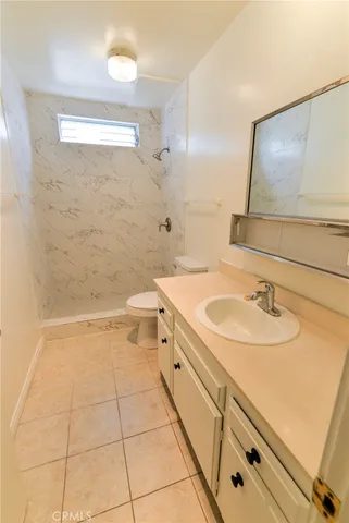 a bathroom with a sink a toilet and mirror