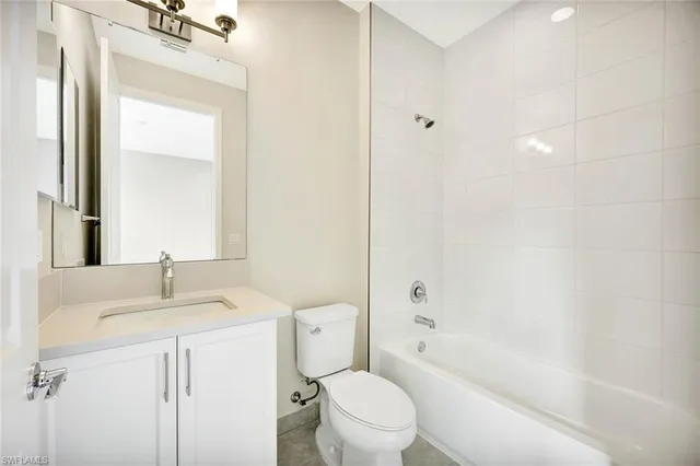 a bathroom with a sink toilet vanity and shower