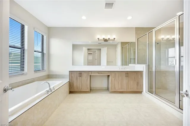 a large spacious bathroom with a large tub and shower