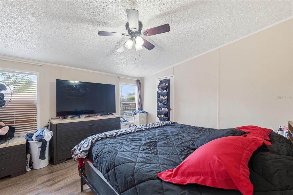 1890 Derosa Road Polk City, FL 33868 - Photo 12 of 20 a bedroom with a bed and a flat screen tv