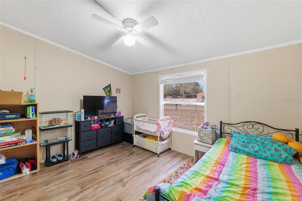 1890 Derosa Road Polk City, FL 33868 - Photo 15 of 20 a bedroom with bed and wooden floor
