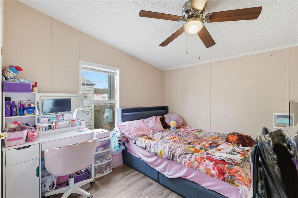 1890 Derosa Road Polk City, FL 33868 - Photo 16 of 20 a bedroom with a bed and a chandelier