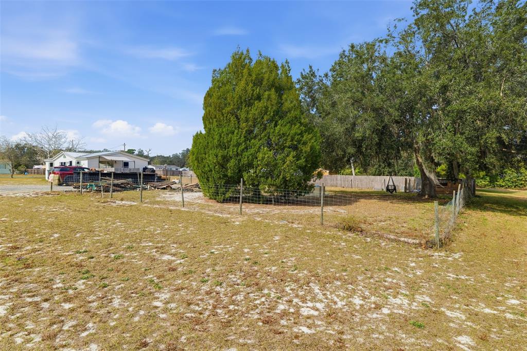 1890 Derosa Road Polk City, FL 33868 - Photo 19 of 20 a swimming pool with outdoor seating and yard