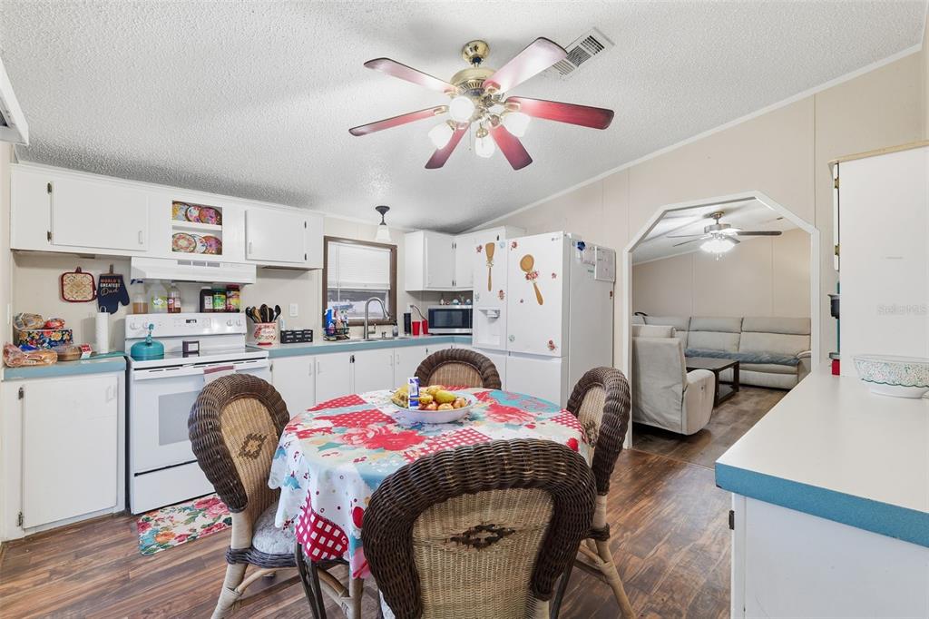 1890 Derosa Road Polk City, FL 33868 - Photo 7 of 20 a bedroom with furniture and a chandelier