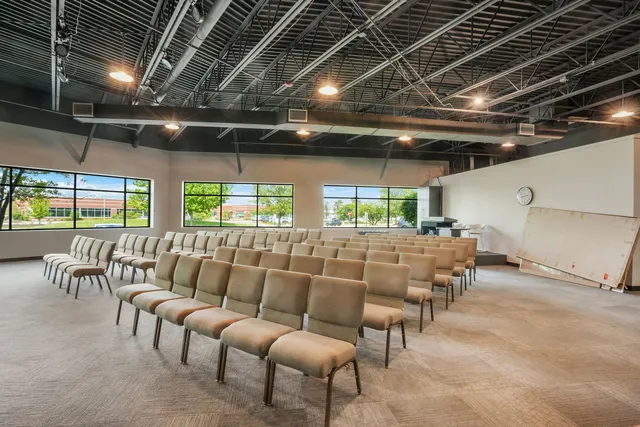 a living room with lots of furniture and a large window