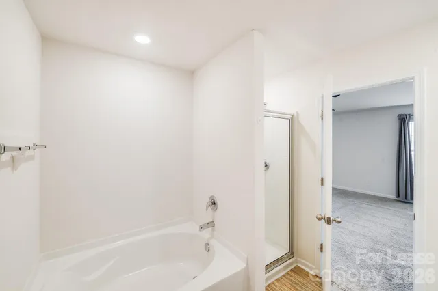 a bathroom with a bathtub and a shower