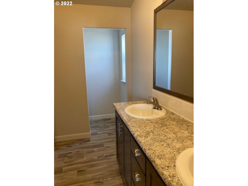 3104 Southwest Terrace Drive Pendleton, OR 97801 - Photo 11 of 18 a bathroom with a granite countertop sink and a mirror