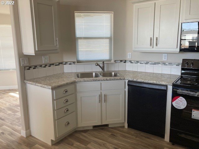 3104 Southwest Terrace Drive Pendleton, OR 97801 - Photo 4 of 18 a kitchen with cabinets appliances a sink and a window