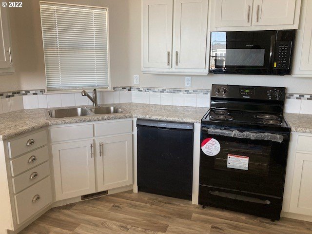 3104 Southwest Terrace Drive Pendleton, OR 97801 - Photo 5 of 18 a kitchen with stainless steel appliances granite countertop a stove microwave and sink