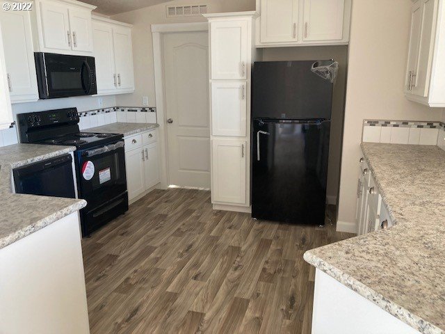 3104 Southwest Terrace Drive Pendleton, OR 97801 - Photo 8 of 18 a kitchen with stainless steel appliances granite countertop a refrigerator a stove top oven a sink and dishwasher
