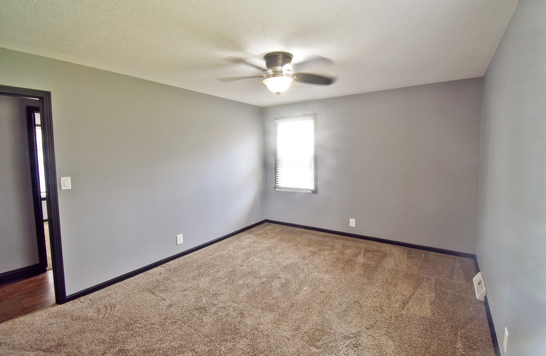 710 Dean Road Clarksville, TN 37040 - Photo 13 of 17 an empty room with a chandelier fan and windows