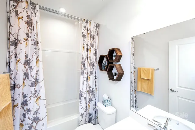 a bathroom with a shower curtain and a sink