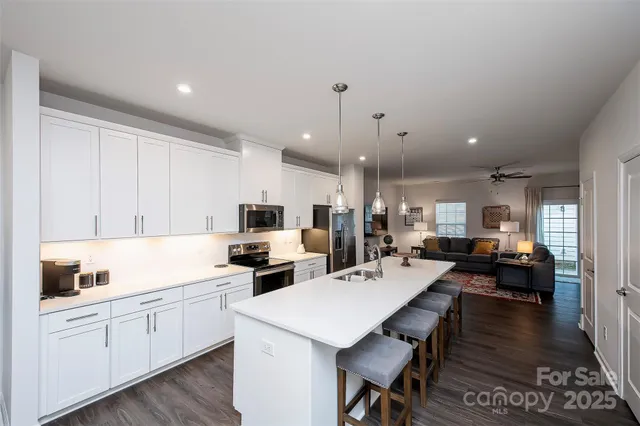 a kitchen with sink refrigerator and cabinets