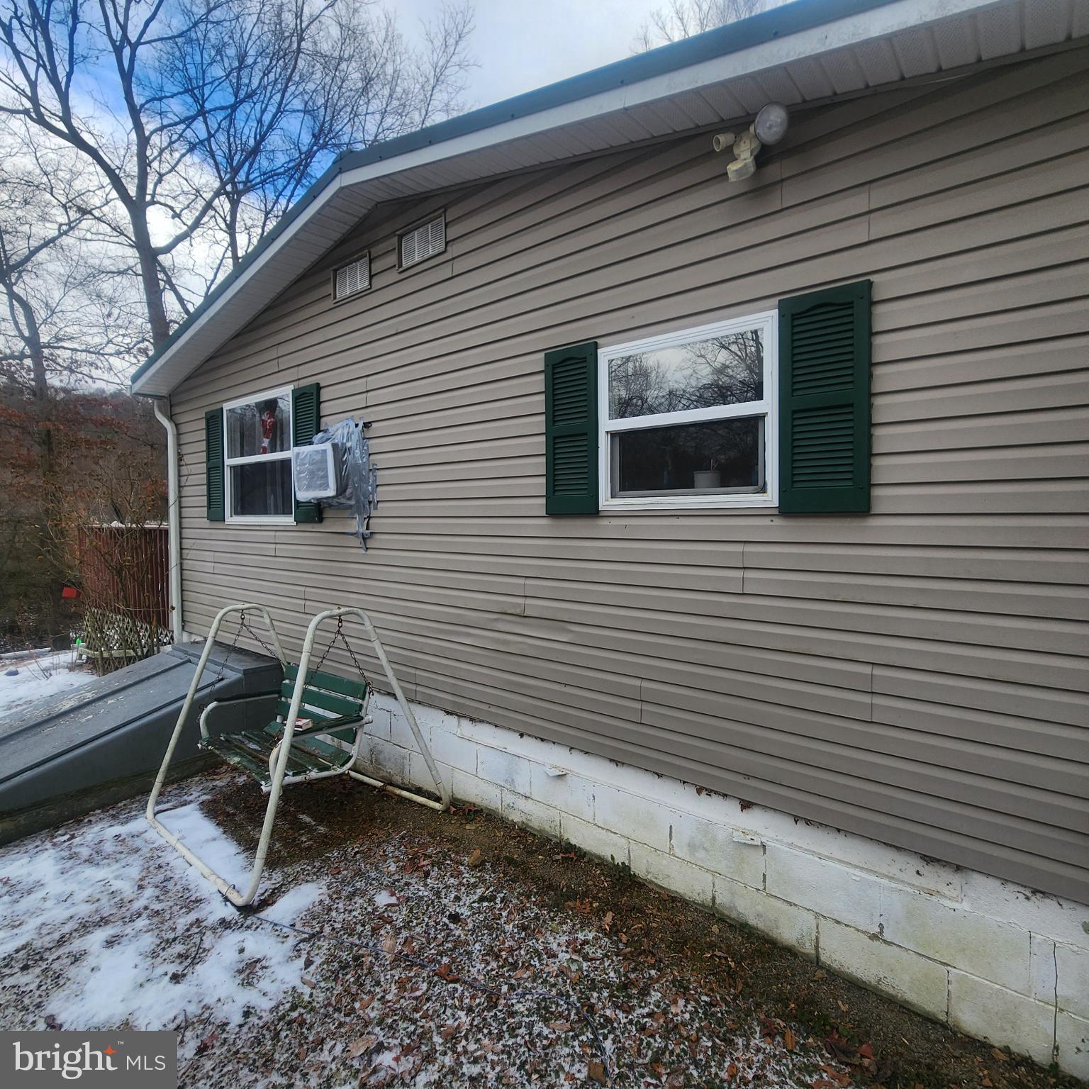749 Clouser Hollow Road New Bloomfield, PA 17068 - Photo 20 of 30 a wooden bench sitting in front of a house