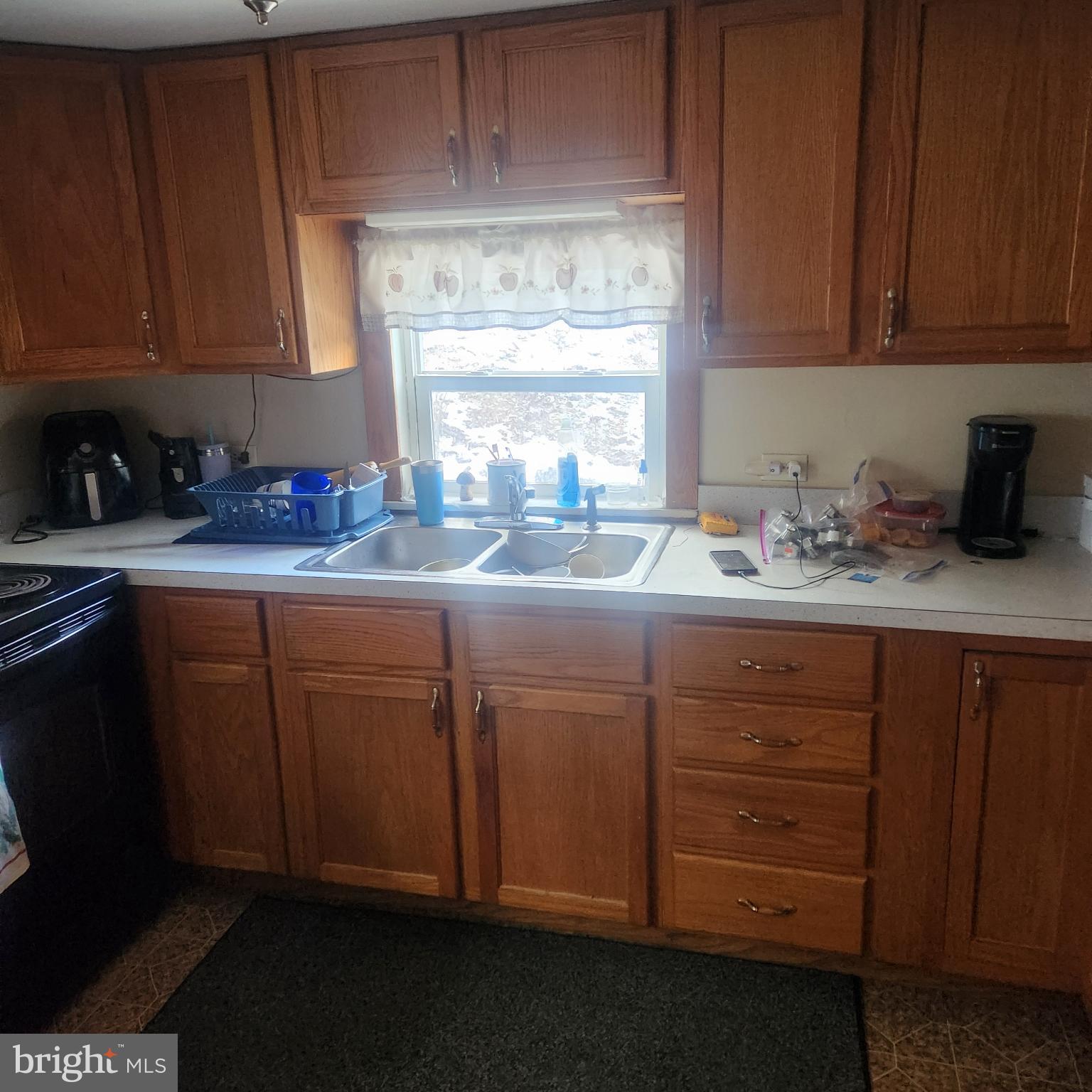 749 Clouser Hollow Road New Bloomfield, PA 17068 - Photo 5 of 30 a kitchen with granite countertop stainless steel appliances a sink window and cabinets