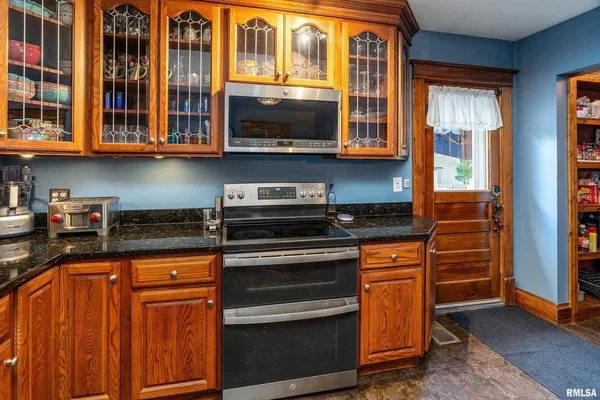 a kitchen with stainless steel appliances granite countertop a stove and cabinets