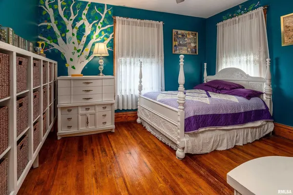 a bedroom with a bed and a dresser