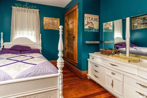 a bathroom with a granite countertop sink a toilet a mirror and vanity