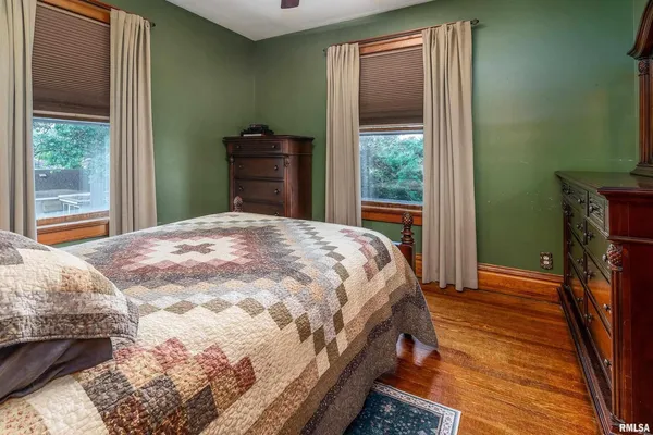 a bedroom with a bed and a dresser