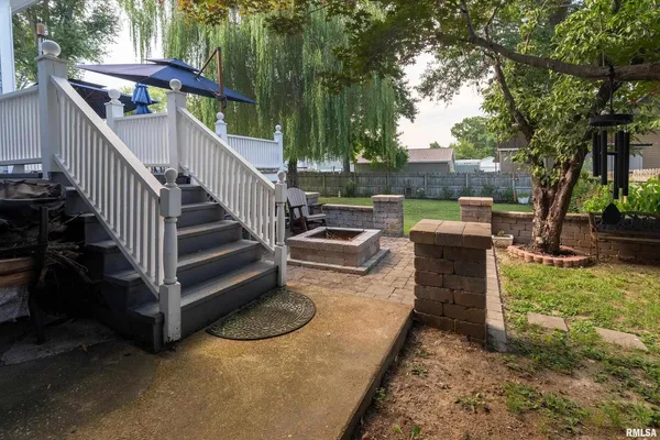 a view of a house with a yard and sitting area