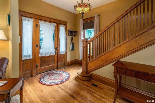 a view of a livingroom with furniture and staircase
