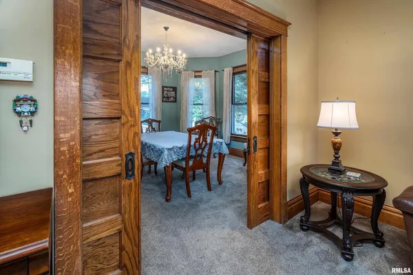 a view of a livingroom with furniture and a lamp