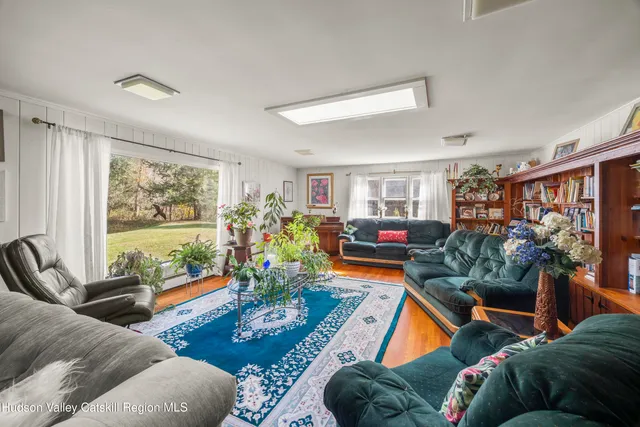 a living room filled with furniture and a floor to ceiling window