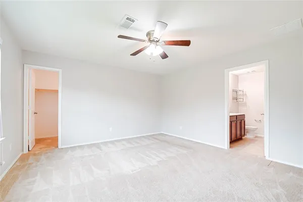a view of a room with a ceiling fan and window